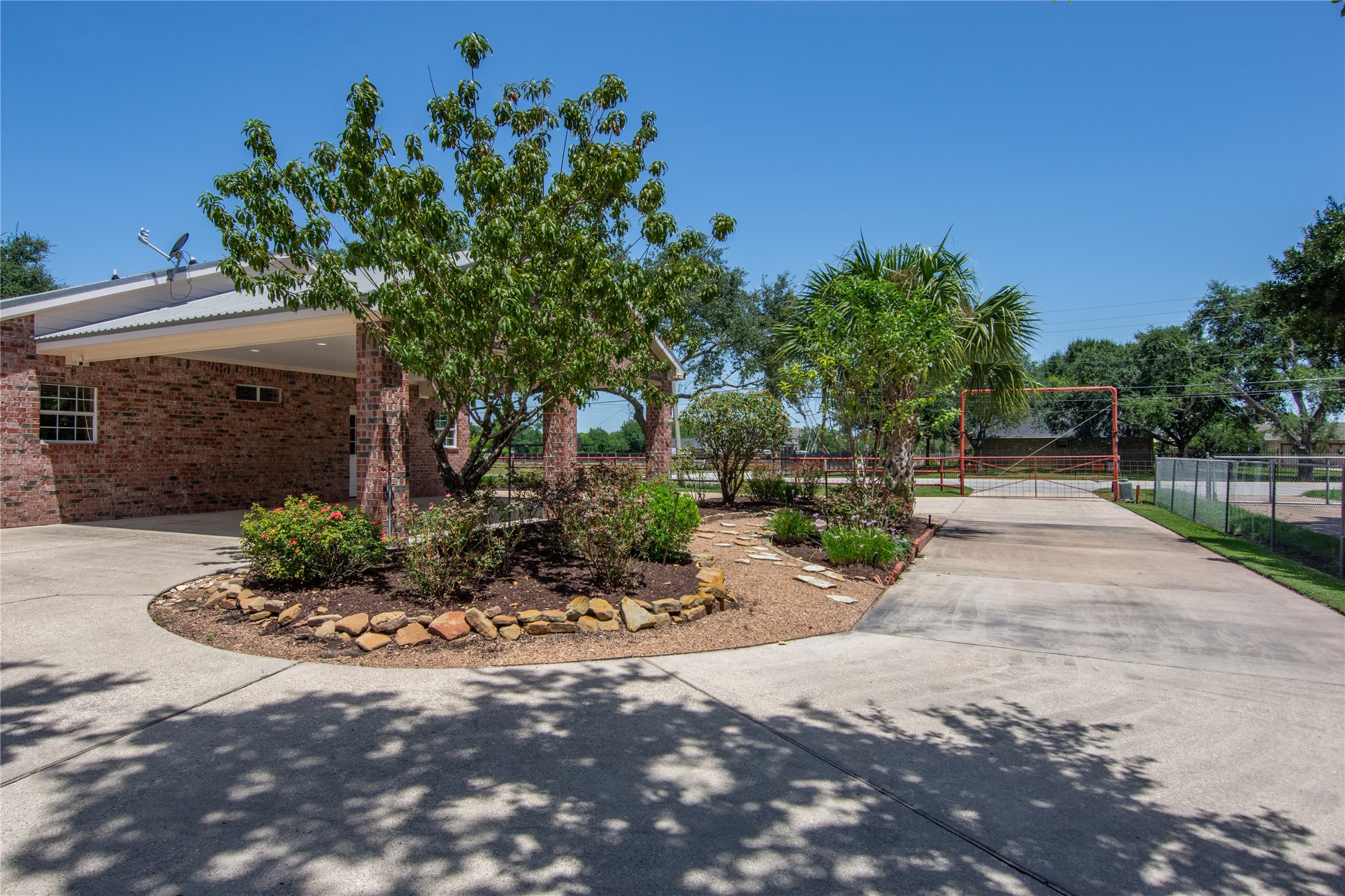 1112 Crenshaw Road Pasadena, TX 77504 - Photo 48 of 50 CIRCLE DRIVEWAY W/ ELECTRIC ENTRY GATE! NOTICE THE LARGE PEACH TREE! HAS GREAT PEACHES EVERY YEAR!