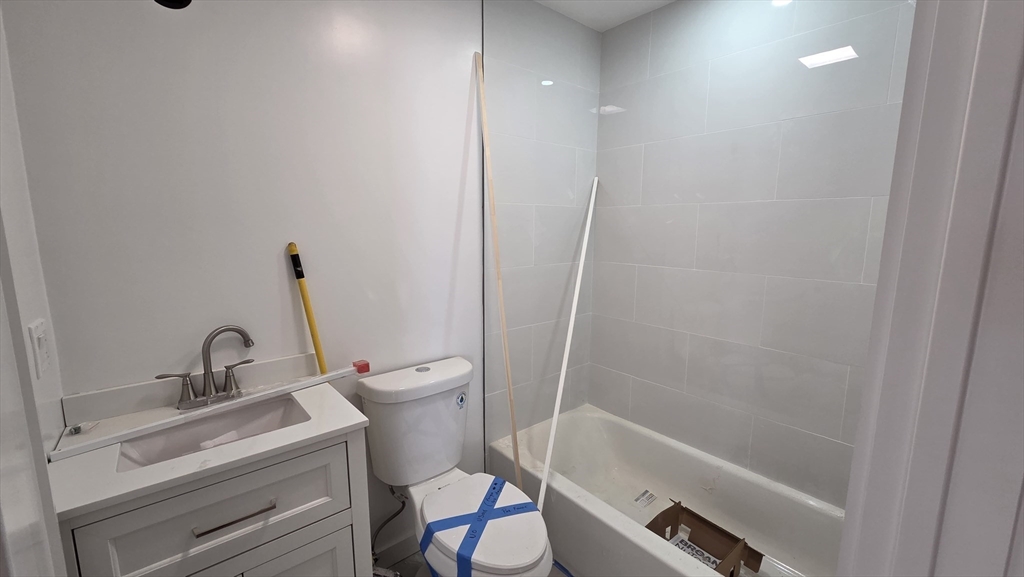 125 Central Avenue, Unit 3 Chelsea, MA 02150 - Photo 12 of 13 a bathroom with a sink a toilet and a bathtub