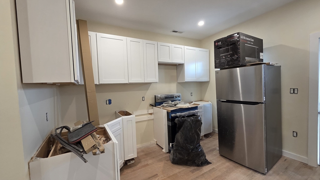 125 Central Avenue, Unit 3 Chelsea, MA 02150 - Photo 9 of 13 a kitchen with a refrigerator and a stove