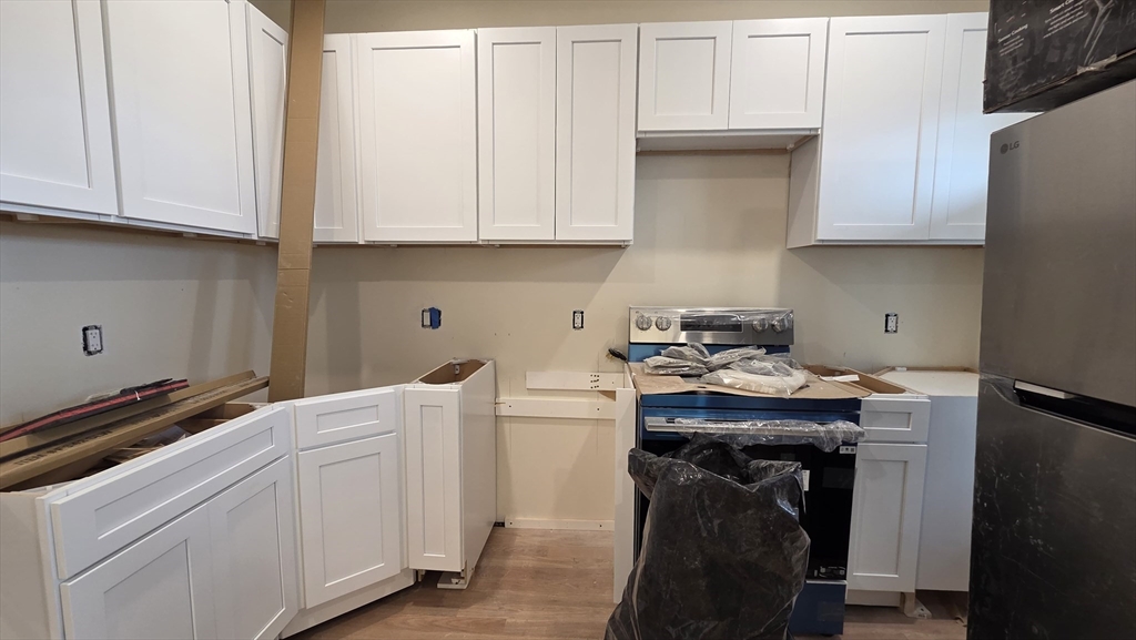 125 Central Avenue, Unit 3 Chelsea, MA 02150 - Photo 10 of 13 a utility room with cabinets