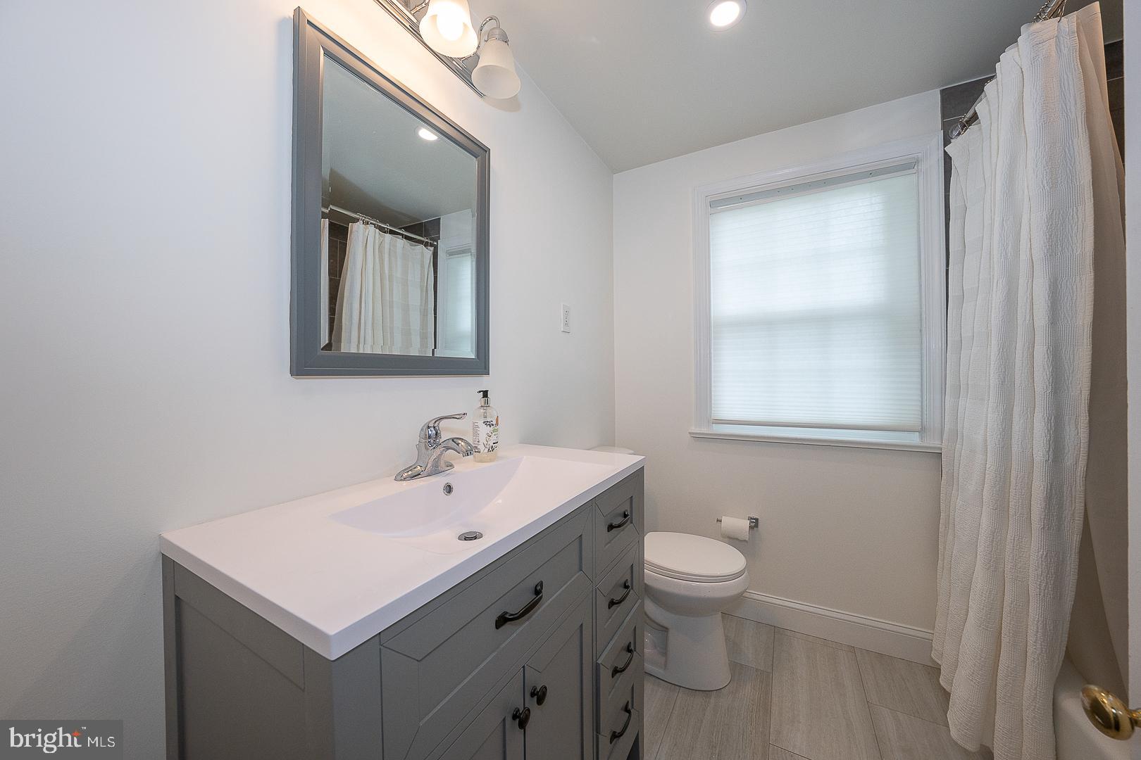 538 Conestoga Road Villanova, PA 19085 - Photo 26 of 39 a bathroom with a sink a toilet and a mirror
