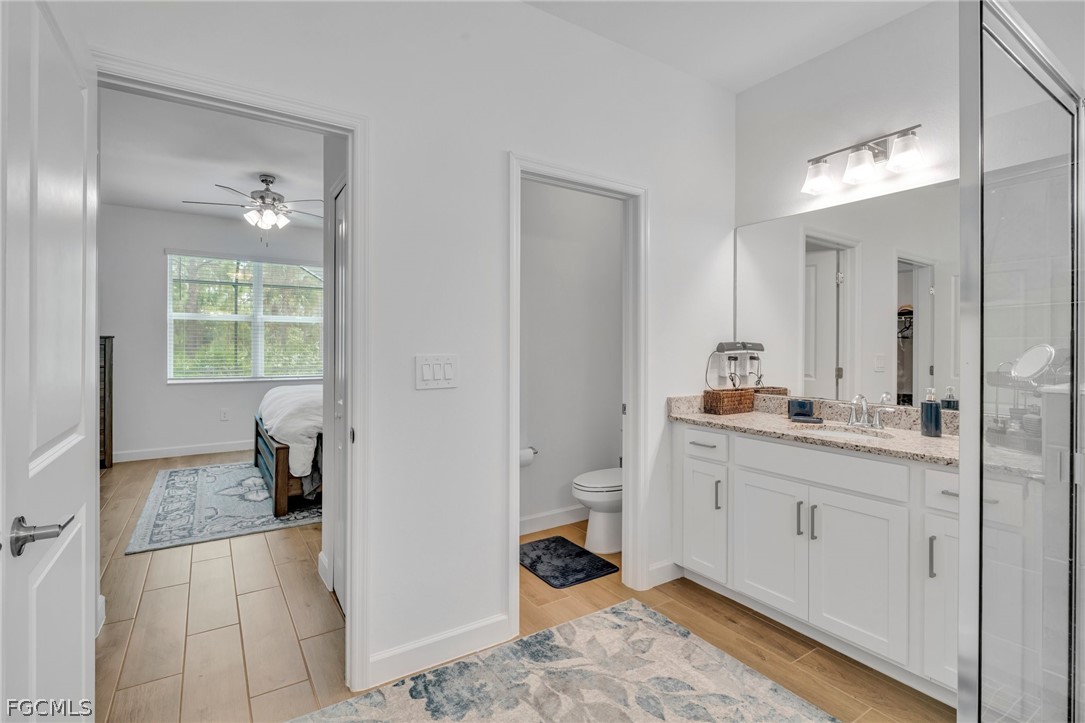 17388 Walnut Run Drive Alva, FL 33920 - Photo 20 of 24 a en suite bathroom with a granite countertop sink and a mirror