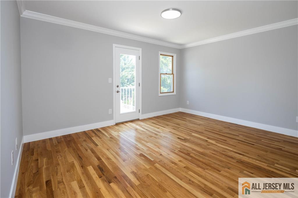 278 Rector Street Perth Amboy, NJ 08861 - Photo 21 of 47 an empty room with wooden floor and windows