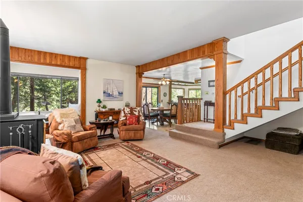 a living room with furniture ceiling fan and a rug