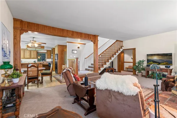 a living room with furniture a rug and a large window