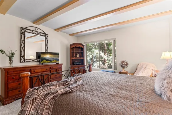 a bedroom with a large bed and a dresser