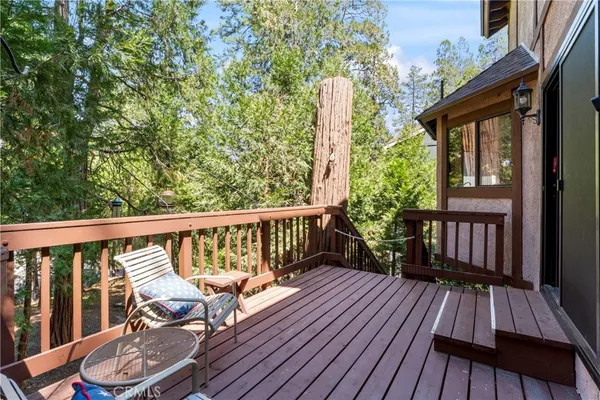 a view of balcony with wooden floor and seating space