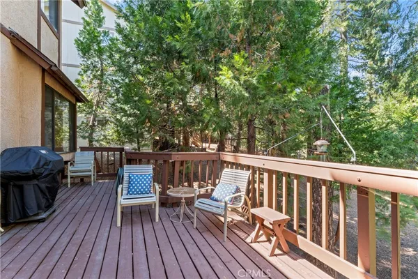 a view of balcony with chairs and wooden fence