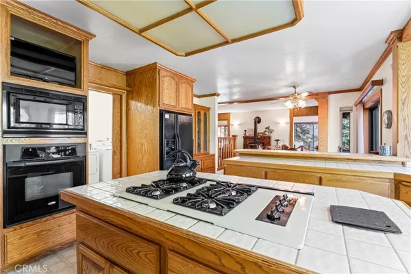 a kitchen with a stove a refrigerator and a sink