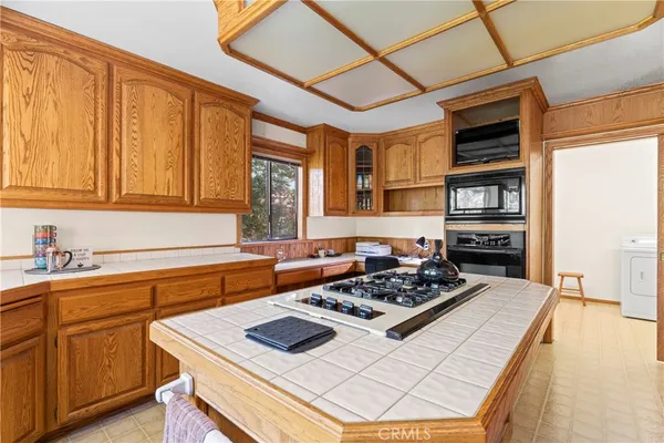 a kitchen with a stove a sink and a refrigerator