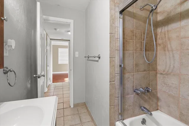 a bathroom with a bathtub and shower
