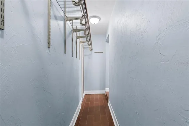 a view of a hallway with wooden floor
