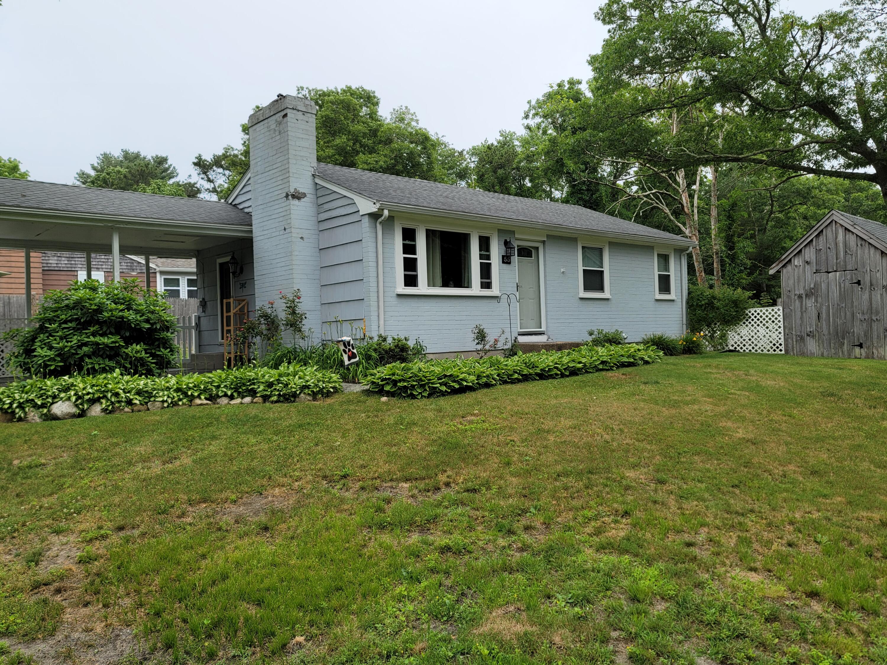a house that has a tree in front of it