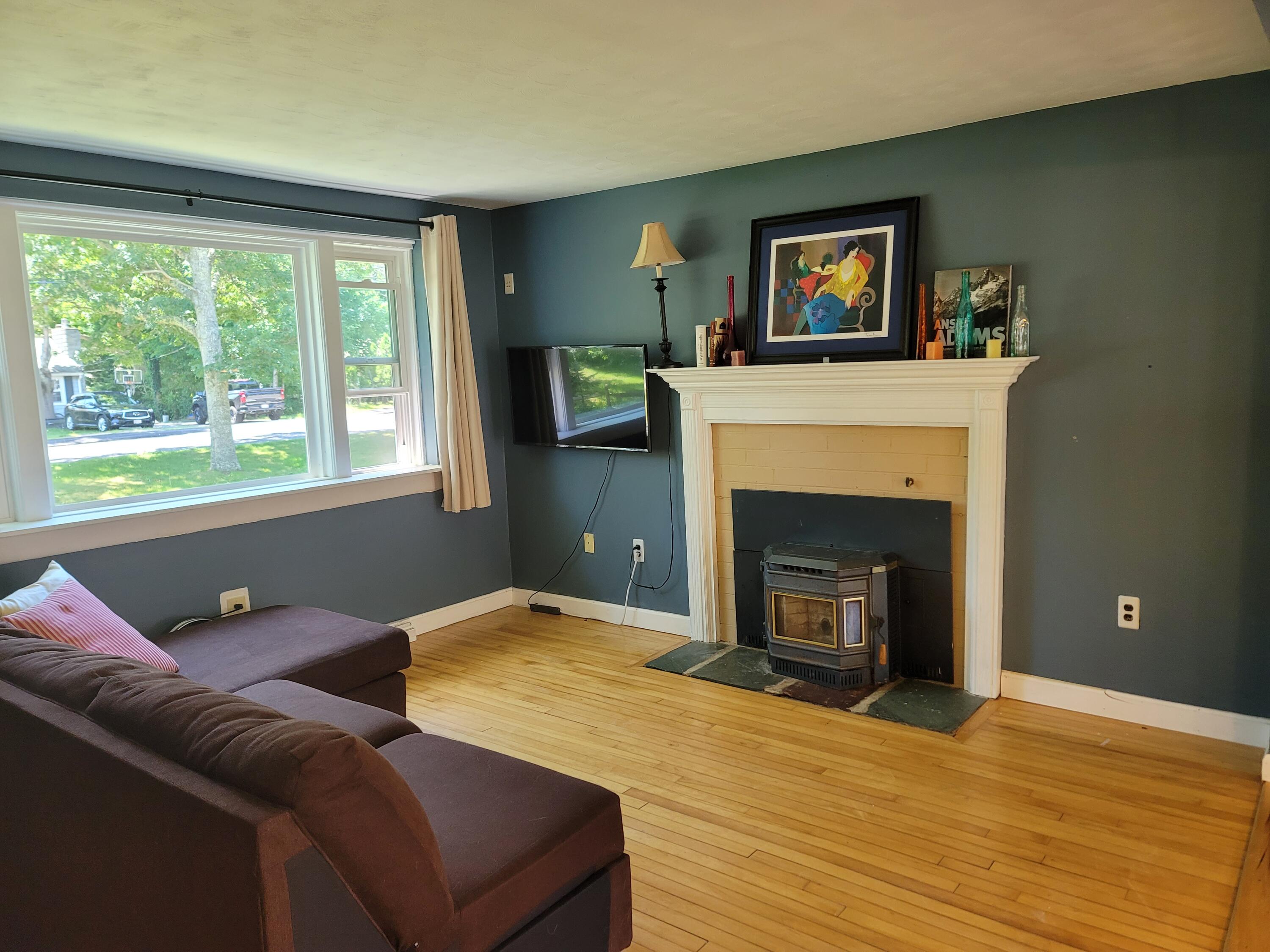 55 Clay Pond Road Monument Beach, MA 02532 - Photo 11 of 15 a bedroom with a bed and a fireplace