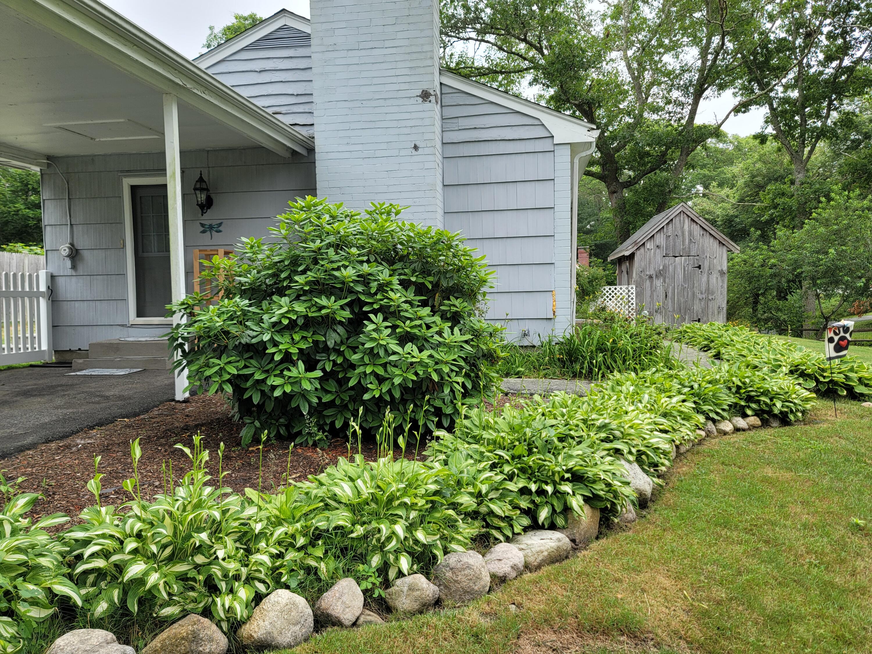55 Clay Pond Road Monument Beach, MA 02532 - Photo 12 of 15 a view of a house with a yard and garden