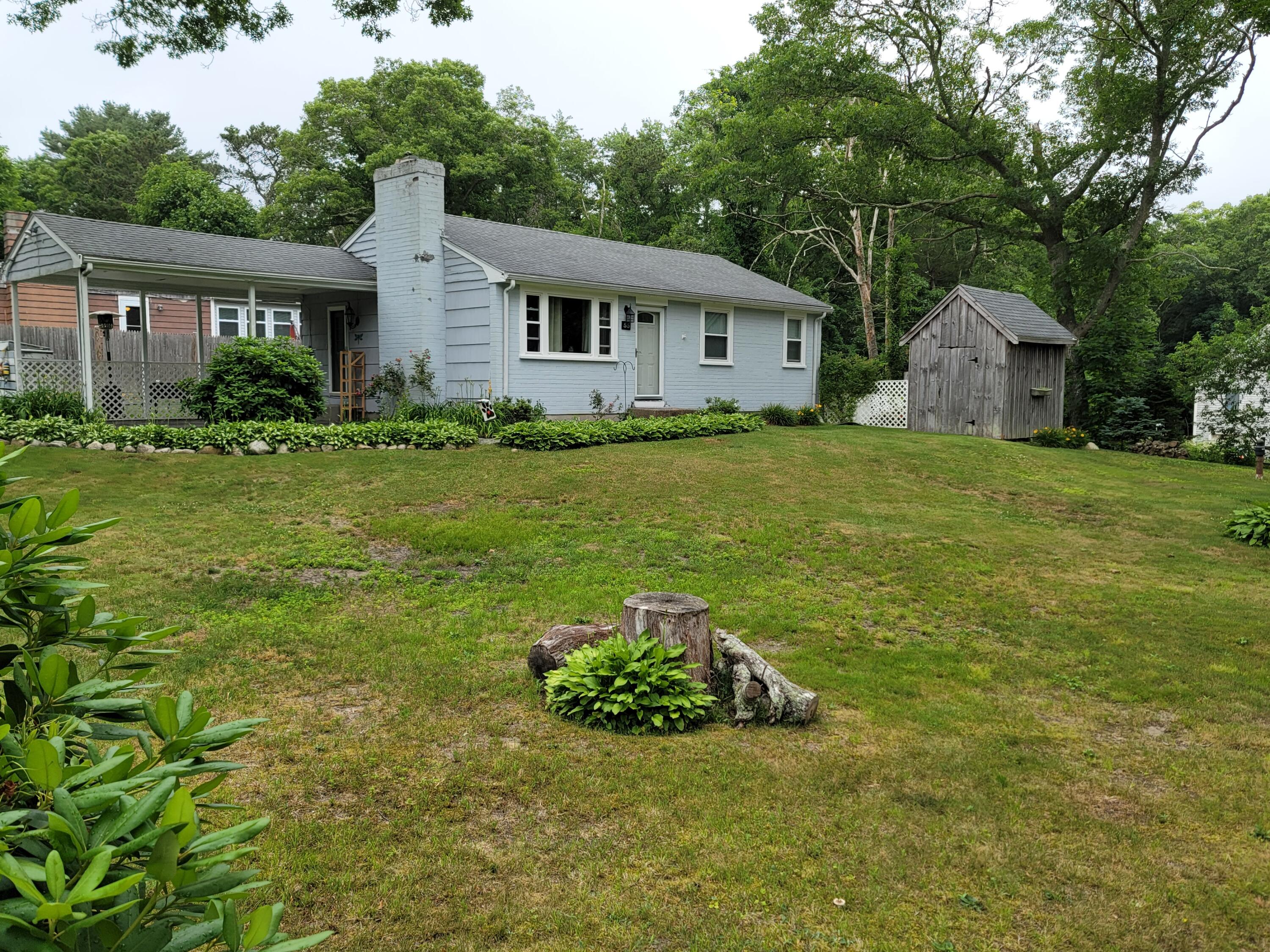 55 Clay Pond Road Monument Beach, MA 02532 - Photo 13 of 15 a view of a house with backyard and garden