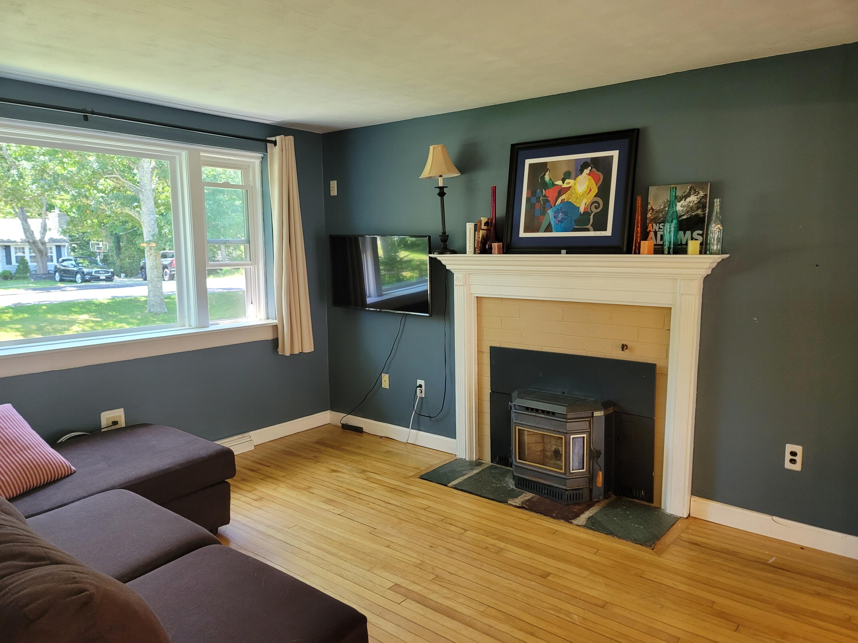 55 Clay Pond Road Monument Beach, MA 02532 - Photo 3 of 15 a bedroom with a bed and a fireplace