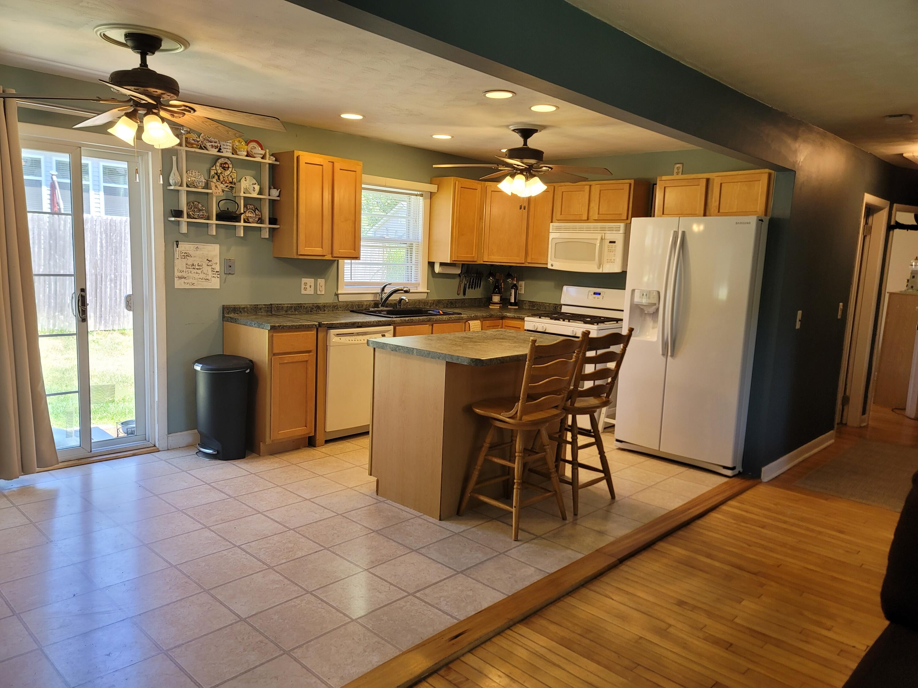 55 Clay Pond Road Monument Beach, MA 02532 - Photo 5 of 15 a kitchen with stainless steel appliances granite countertop a refrigerator a sink a stove and island