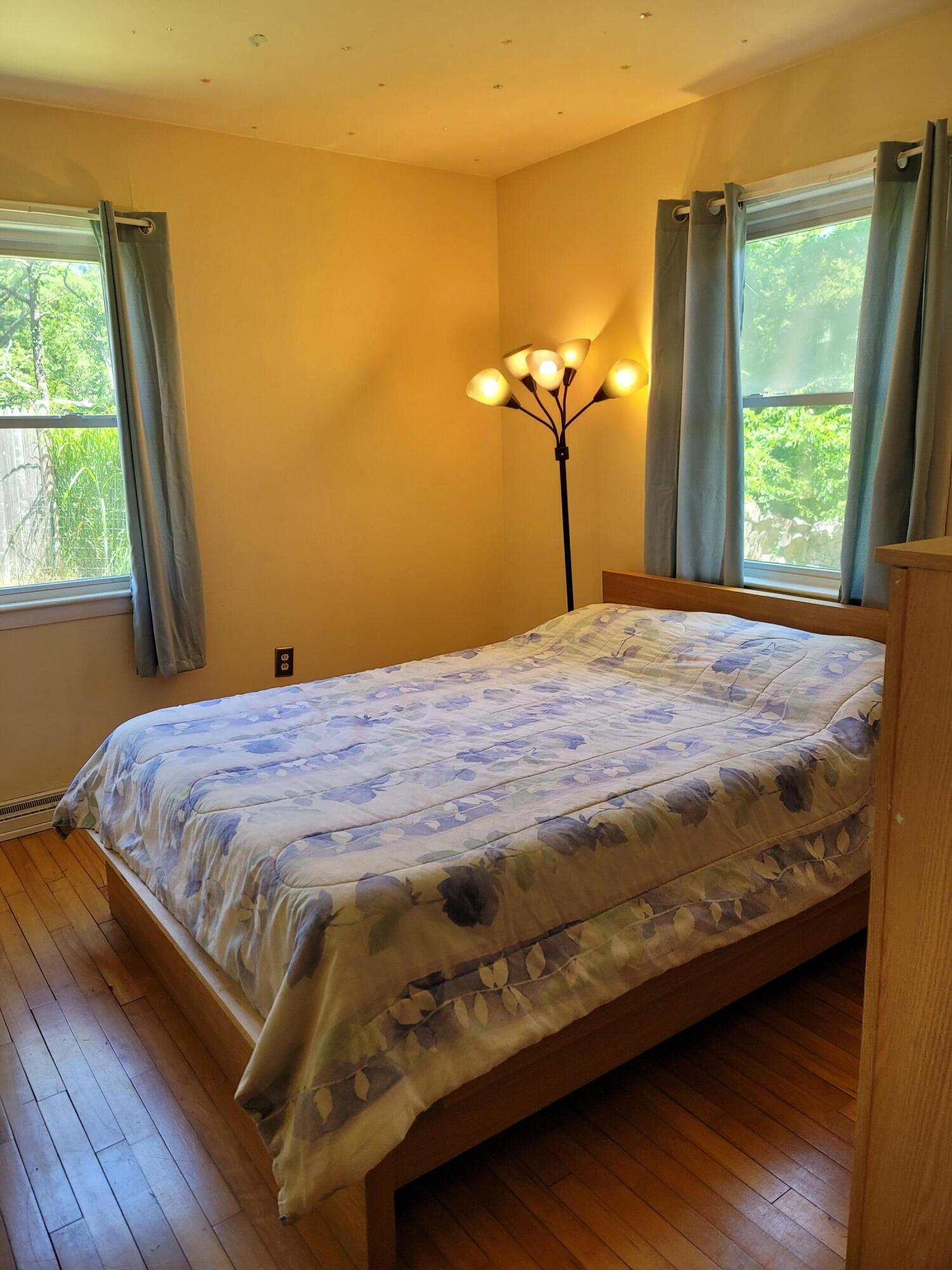 55 Clay Pond Road Monument Beach, MA 02532 - Photo 8 of 15 a bed sitting in a bedroom next to a window