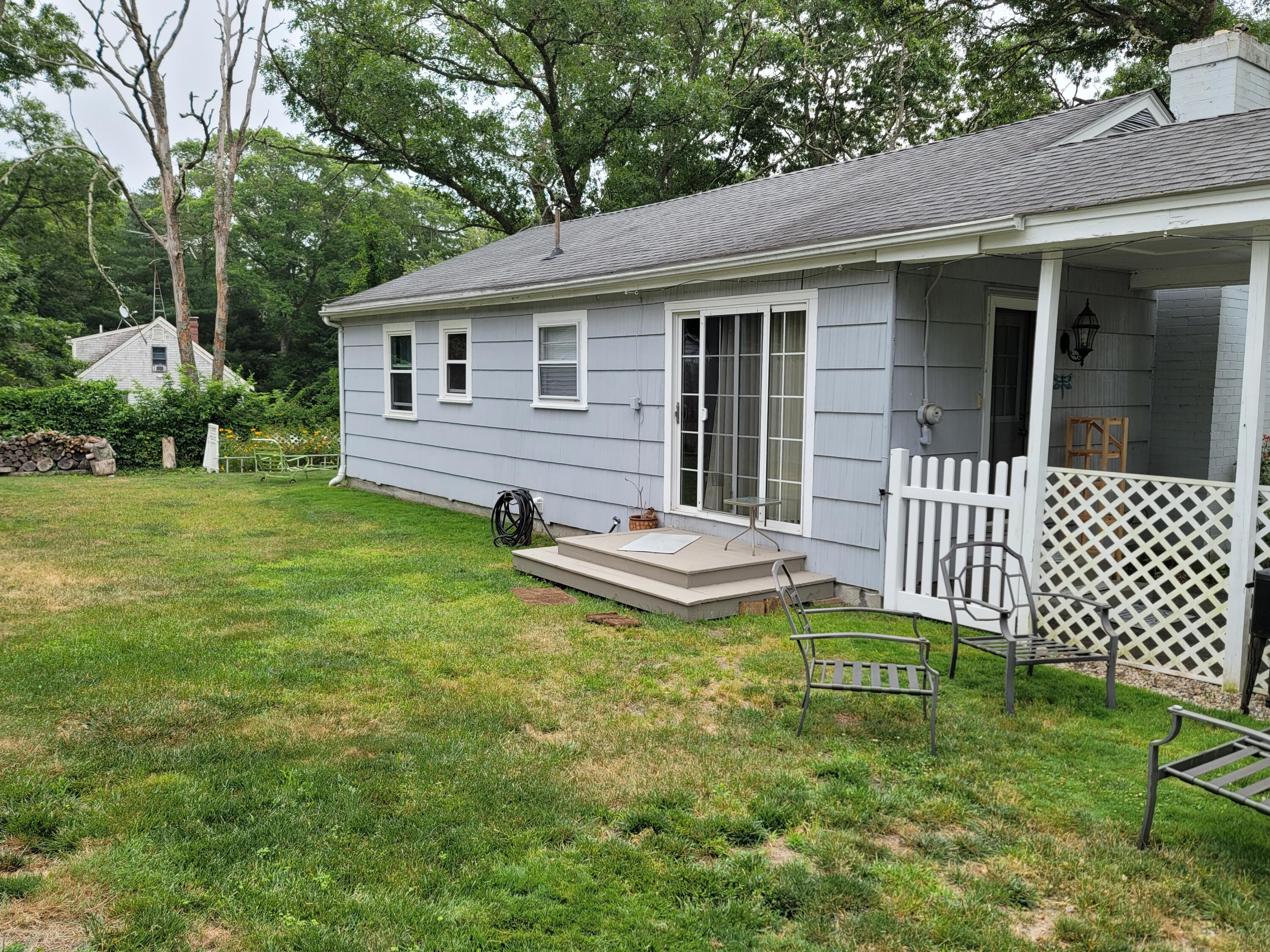 55 Clay Pond Road Monument Beach, MA 02532 - Photo 10 of 15 a view of a house with backyard and sitting area