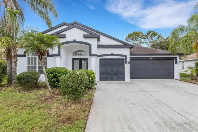a front view of a house with a yard and garage