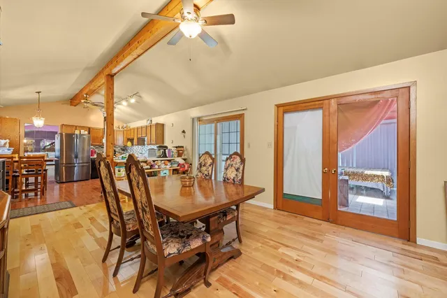 a view of a dining room with furniture and chandelier