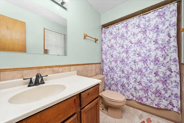 a bathroom with a sink a toilet and a mirror