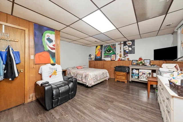 a bedroom with furniture and a flat screen tv