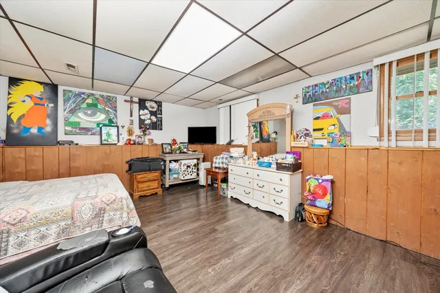 a bed room with furniture and flat screen tv