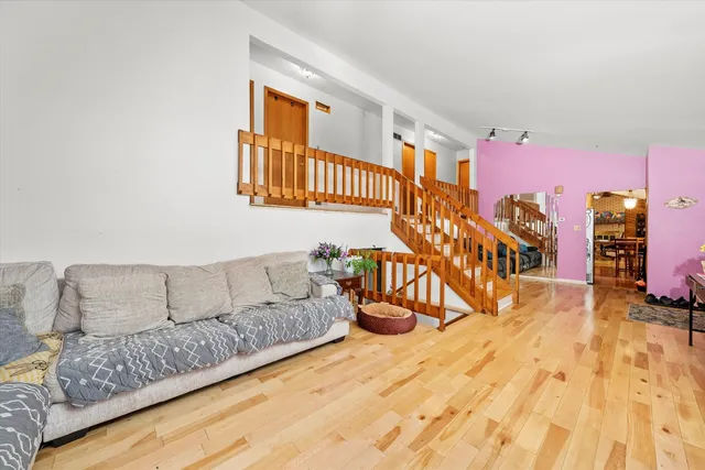 a living room with furniture and a wooden floor