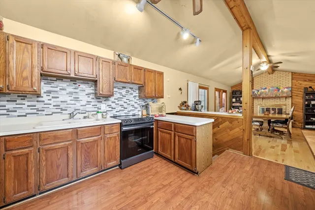 a kitchen with stainless steel appliances granite countertop a stove and cabinets