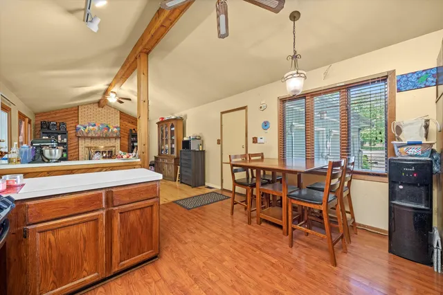 a large kitchen with a table and chairs
