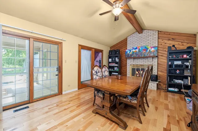 a dining room with furniture a chandelier and wooden floor