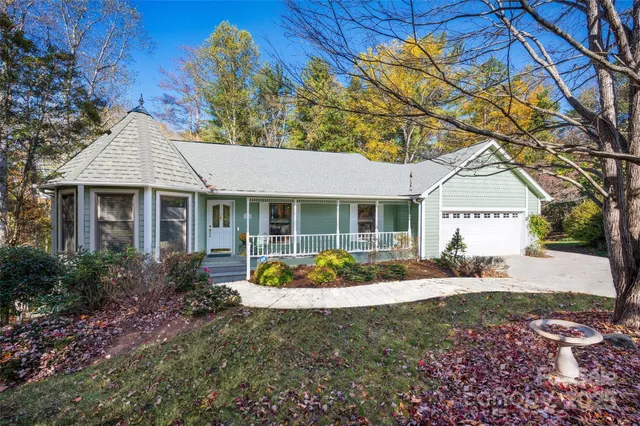 a front view of a house with garden and porch