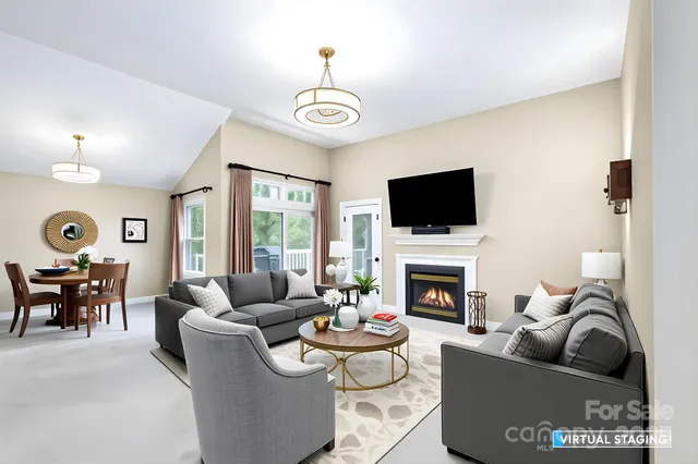 a living room with fireplace furniture and a flat screen tv