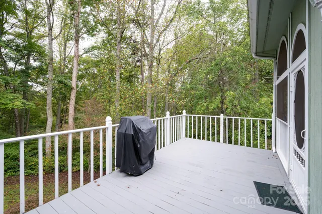 a balcony with wooden floor and fence