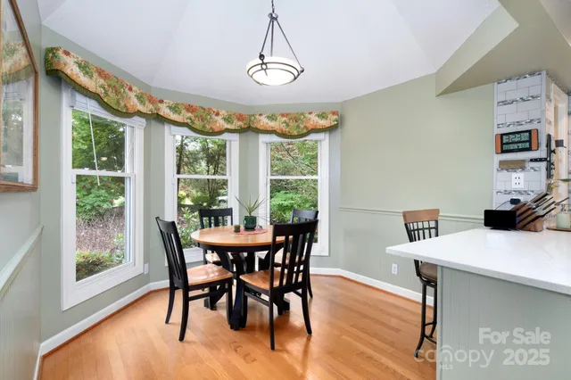 a view of a dining room with furniture window and wooden floor