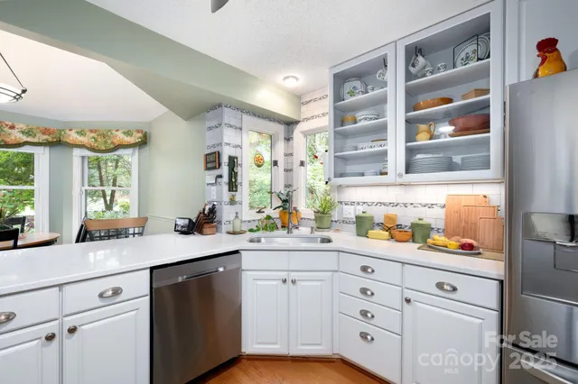 a kitchen with cabinets appliances and a window