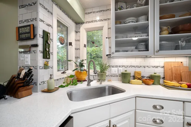 a kitchen with a sink and a stove top oven