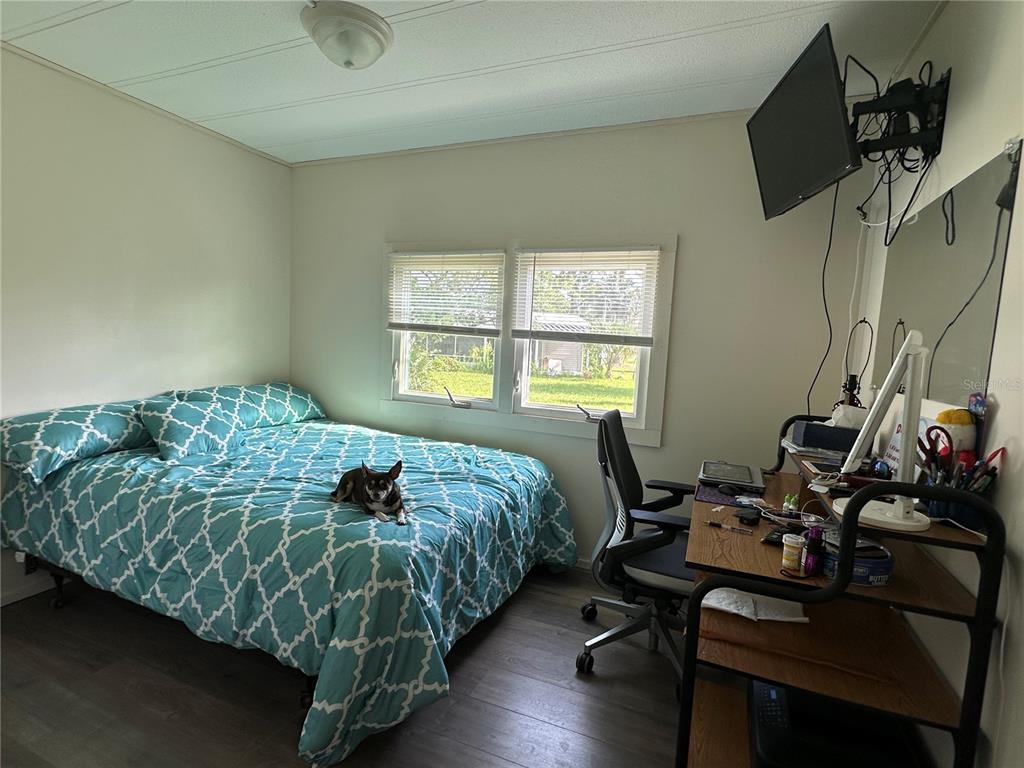 55045 6th Street Astor, FL 32102 - Photo 12 of 38 a bedroom with a bed and a window