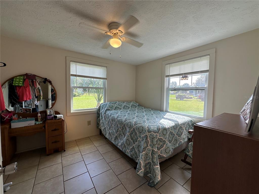 55045 6th Street Astor, FL 32102 - Photo 14 of 38 a bedroom with a bed and a window