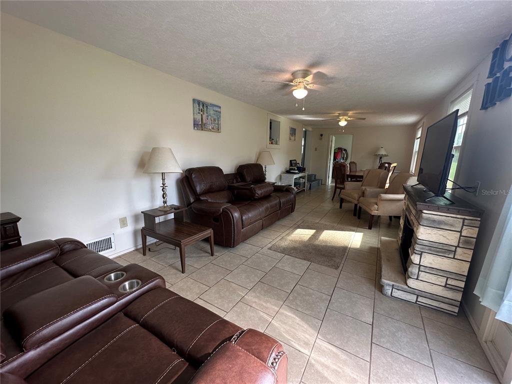 55045 6th Street Astor, FL 32102 - Photo 17 of 38 a living room with furniture and a flat screen tv