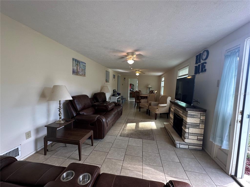 55045 6th Street Astor, FL 32102 - Photo 18 of 38 a living room with furniture and a flat screen tv