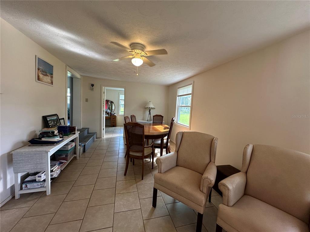 55045 6th Street Astor, FL 32102 - Photo 19 of 38 a living room with furniture and a chandelier