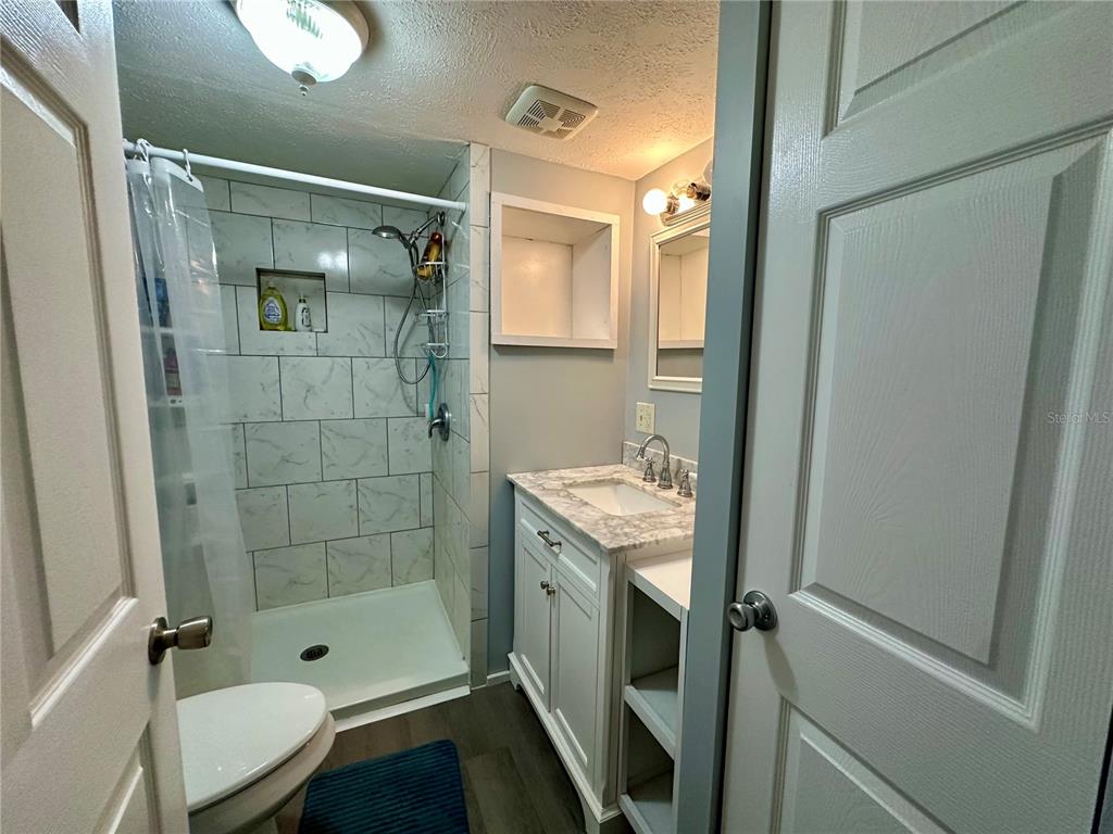 55045 6th Street Astor, FL 32102 - Photo 23 of 38 a bathroom with a shower and a sink