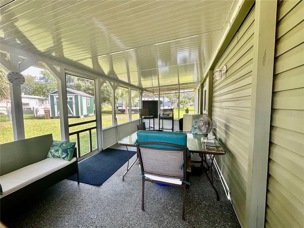 55045 6th Street Astor, FL 32102 - Photo 25 of 38 a porch with outdoor seating