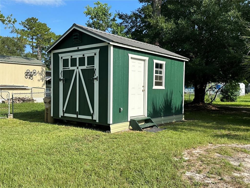 55045 6th Street Astor, FL 32102 - Photo 27 of 38 a front view of a house with garden