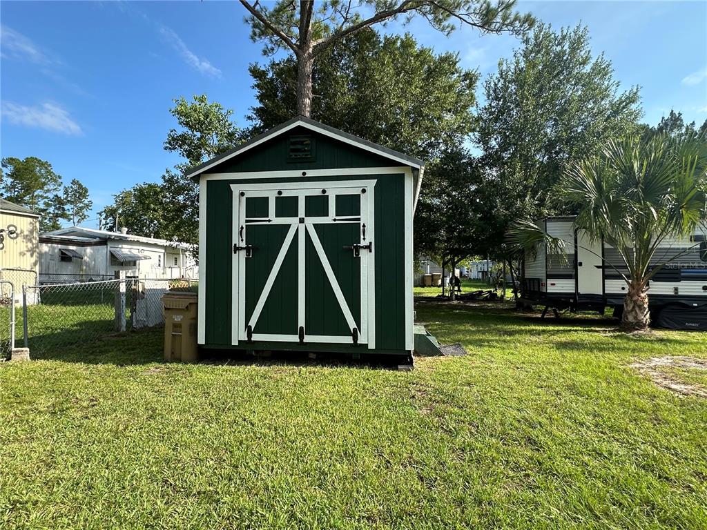 55045 6th Street Astor, FL 32102 - Photo 28 of 38 a front view of a house with garden