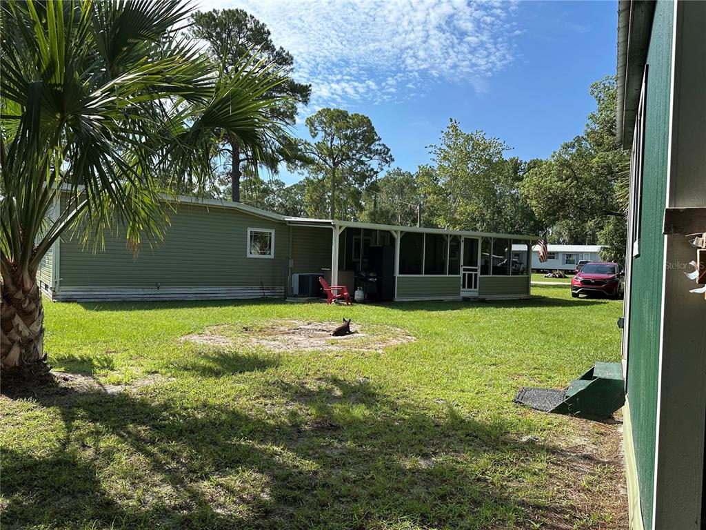 55045 6th Street Astor, FL 32102 - Photo 30 of 38 a backyard of a house with lots of green space