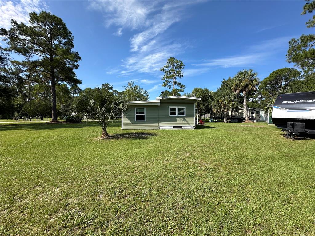 55045 6th Street Astor, FL 32102 - Photo 35 of 38 a view of a house with a backyard